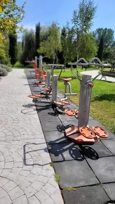 a row of benches lined up on a sidewalk at Wonderful Deluxe Appartement in Cascadas Family Resort Sunny Beach in Sunny Beach