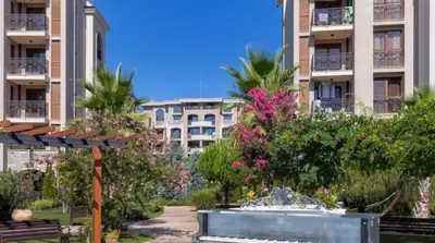 a park in front of a building with a fountain at Wonderful Deluxe Appartement in Cascadas Family Resort Sunny Beach in Sunny Beach