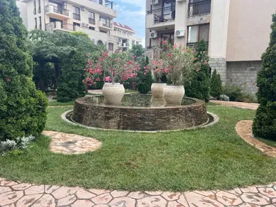 a garden with three vases with flowers in it at Wonderful Deluxe Appartement in Cascadas Family Resort Sunny Beach in Sunny Beach