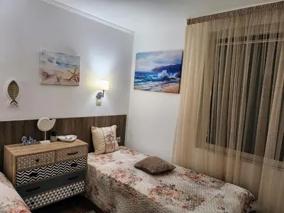 a bedroom with two beds and a window at Синьо лято /Blue summer in Sunny Beach