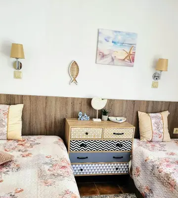 a bedroom with two twin beds and a dresser at Синьо лято /Blue summer in Sunny Beach