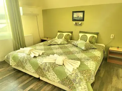 a bedroom with a bed with towels on it at Penthouse Apartments PERLA, Vasiliko in Tsarevo