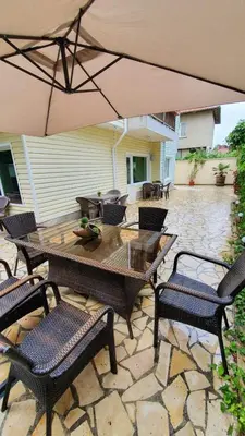 a patio with a table and chairs and an umbrella at Penthouse Apartments PERLA, Vasiliko in Tsarevo