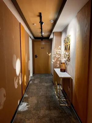 a hallway with a door and a table in a room at MM Boutique Hotel in Burgas City