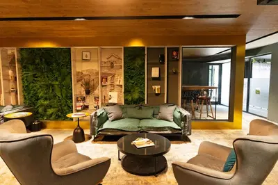 a living room with a green couch and chairs at MM Boutique Hotel in Burgas City