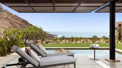 a patio with two chairs and a table next to a pool at SIANA4 in Sveti Vlas