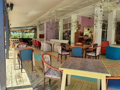 a restaurant with tables and chairs in a room at Apartament Sea Fort Club Grand Resort Fort Noks Sveti Vlas-Bastet BS in Elenite