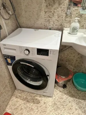 a washing machine in a bathroom next to a sink at AVALON, Apartment C102 in Sunny Beach