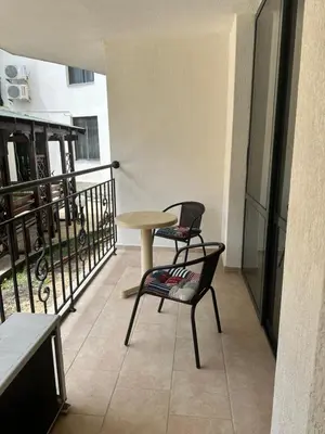 a table and two chairs sitting on a balcony at AVALON, Apartment C102 in Sunny Beach