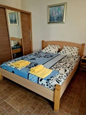 a bedroom with a large bed with a mirror at Цар Калоян in Primorsko