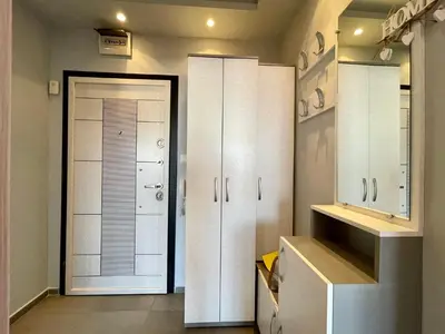 a bathroom with white cabinets and a large door at Апартамент Чаролит / Apartment Charoite in Burgas City
