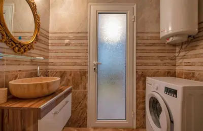 a bathroom with a sink and a washing machine at Sweet Homes 2 Holiday Apartment in Sunny Beach