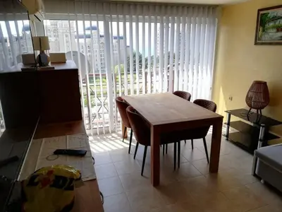 a living room with a table and chairs and a large window at Ferienwohnung mit Meerblick! in Sveti Vlas