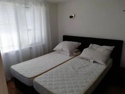 a bed with two pillows on it in a bedroom at Ferienwohnung mit Meerblick! in Sveti Vlas