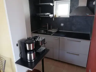 a small kitchen with a coffee maker on a table at Ferienwohnung mit Meerblick! in Sveti Vlas