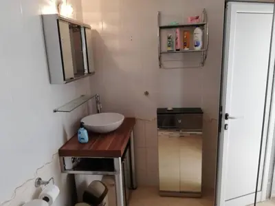 a small bathroom with a sink and a mirror at Ferienwohnung mit Meerblick! in Sveti Vlas