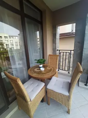 a balcony with a table and chairs on a balcony at Апартамент Blue в местност Каваци, Созопол in Sozopol