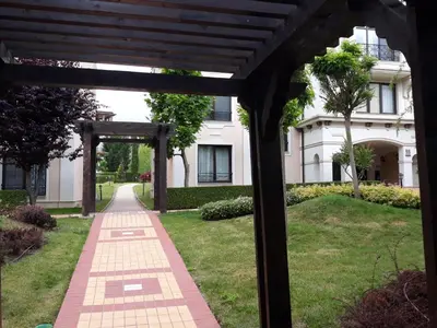 a gazebo in front of a white building at Апартамент Blue в местност Каваци, Созопол in Sozopol