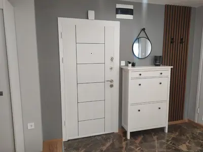 a white closet with a dresser and a mirror at Студио Ирма in Burgas City