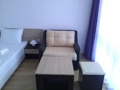 a room with a bed and a couch and a table at Villa Lazuren Bryag 2 in Chernomorets
