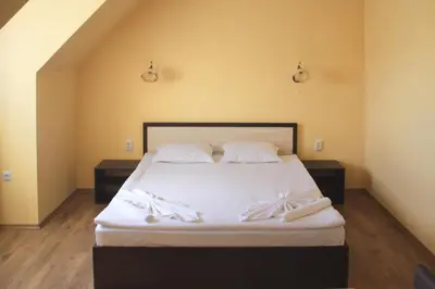 a bedroom with a bed with white sheets and pillows at Horizont Apartments in Sunny Beach