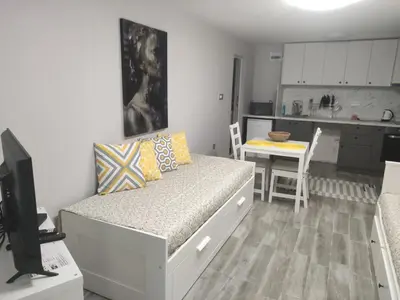 a small bedroom with a bed and a kitchen at Студио за нощувки в центъра на град Бургас. in Burgas City