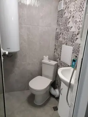 a small bathroom with a toilet and a sink at Студио за нощувки в центъра на град Бургас. in Burgas City
