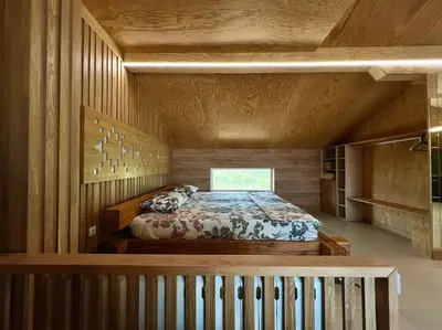 a bedroom with a bed in a room with wooden walls at Seagull Studio Byala in Byala