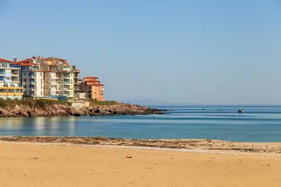 a view of a beach with buildings in the background at Polina Beach in Sozopol