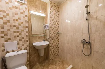 a bathroom with a toilet and a sink and a shower at Polina Beach in Sozopol