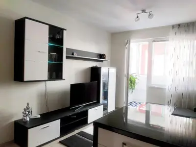 a living room with a television and a black counter top at Modern apartment in Burgas in Burgas City