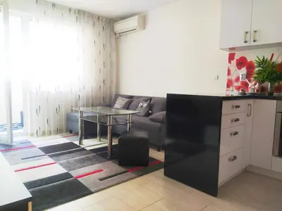 a living room with a couch and a table at Modern apartment in Burgas in Burgas City