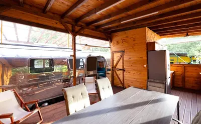 a dining room with a table and chairs and a van at Luxury Vintage Airstream RV/Caravan Retro Charm Meets Comfort in Kiten
