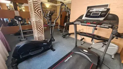 a gym with several exercise bikes and a treadmill at Sweet Home 2 Apartment in Sunny Beach