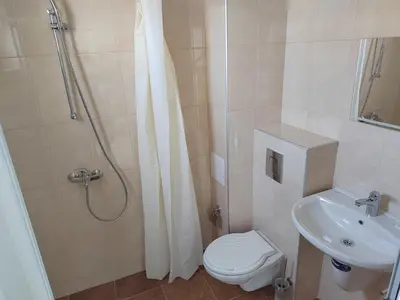 a bathroom with a shower and a toilet and a sink at ARIA in Primorsko