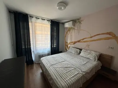 a bedroom with a bed and a large window at Desis Seaside Hideaway in Pomorie
