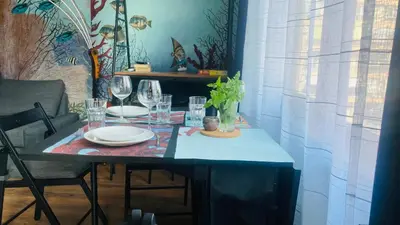a table with plates and wine glasses on it at Desis Seaside Hideaway in Pomorie