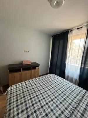 a bedroom with a bed with a checkered blanket at Desis Seaside Hideaway in Pomorie