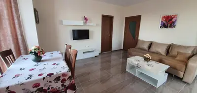 a living room with a couch and a table at Luxury Apartments Ekaterina in Chernomorets