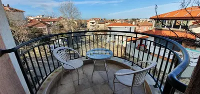 a balcony with a table and chairs on a balcony at Luxury Apartments Ekaterina in Chernomorets