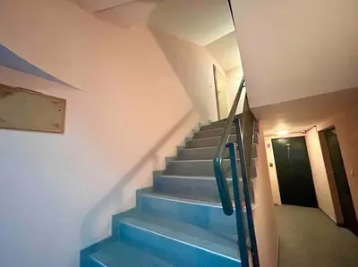a staircase with blue steps in a building at By The Sea Apartment in Varna City