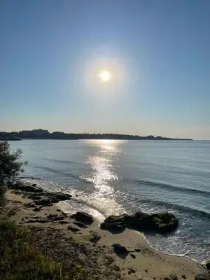 a view of the ocean with the sun rising over the water at Ив-Бо in Ravda