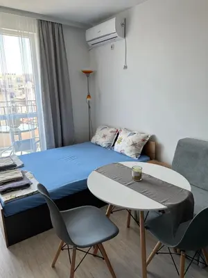 a room with a bed and a table and chairs at Ив-Бо in Ravda