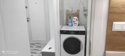 a washer and dryer in a corner of a room at Apartment Krisiya in Burgas in Burgas City