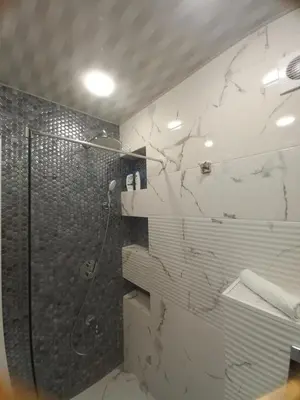 a bathroom with a shower and a toilet at Apartment Krisiya in Burgas in Burgas City