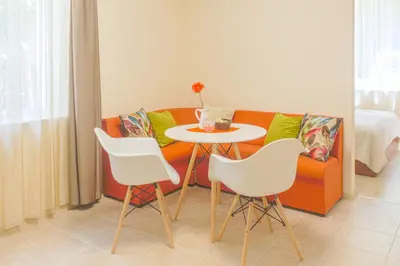 a living room with a couch and a table and chairs at Central location and FREE parking in Varna City