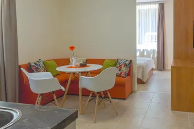 a living room with a couch and a table and chairs at Central location and FREE parking in Varna City