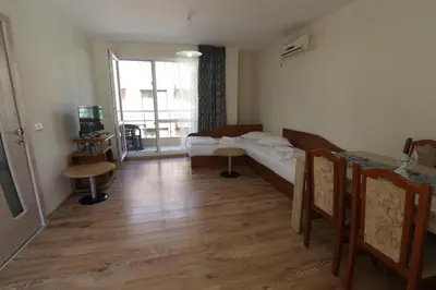 a living room with a couch and a table at апартамент Зевс in Pomorie