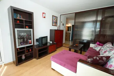 a living room with a couch and a tv at Santa Cruz apartment in Burgas City