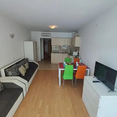 a living room with a couch and a table at Sunny Holiday - Cacao Beach Apartments in Sunny Beach